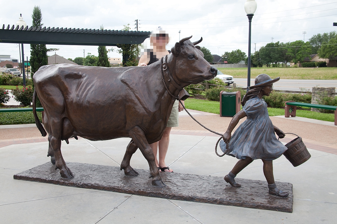 large outdoor garden bronze bull sculpture with girl